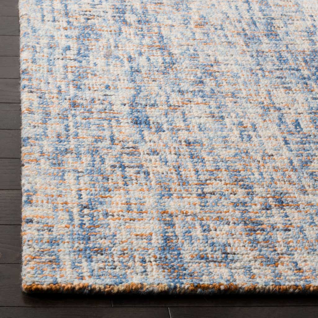 Soft wool pile and a neat bound edge highlight the blue-and-rust rug's textured finish.