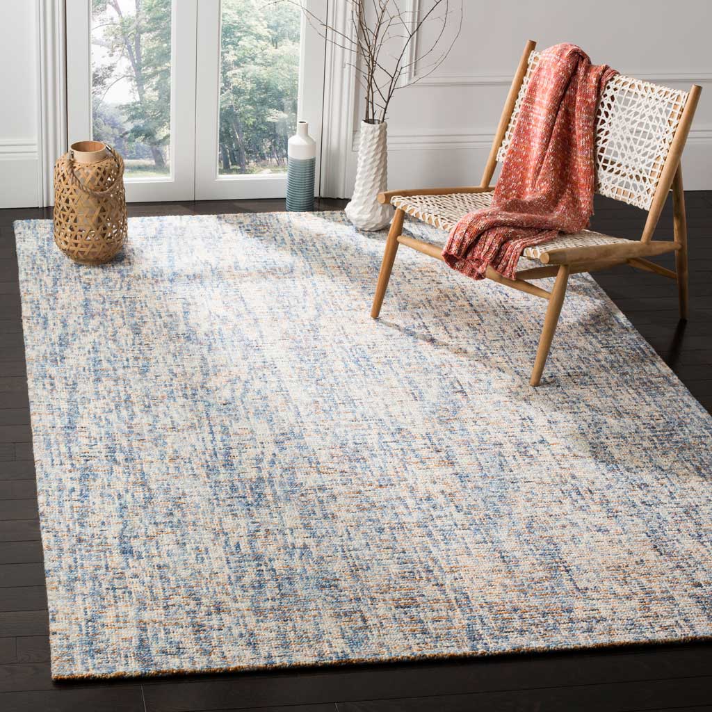 Blue and rust wool fibers bring layered color and cozy texture to a bright living space.