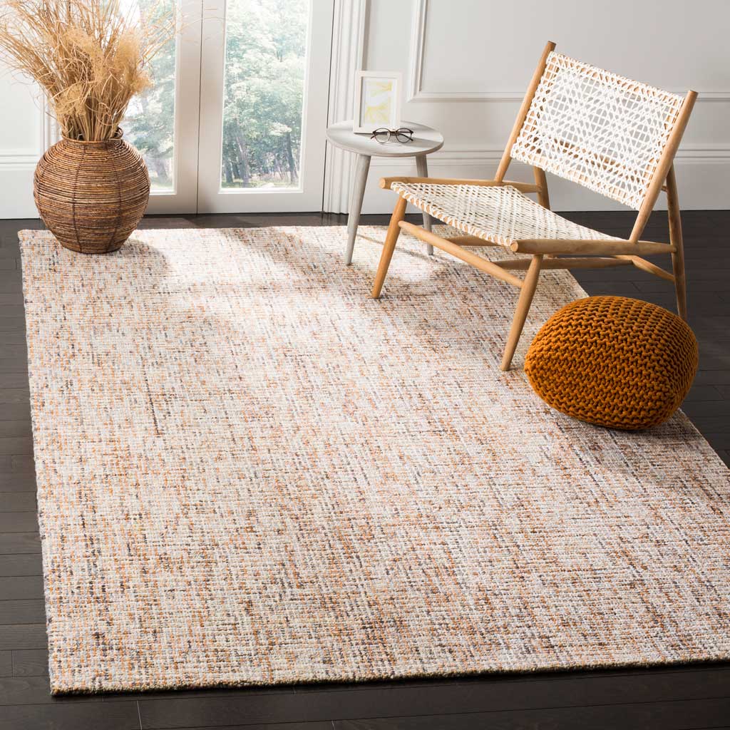 Warm gold and blue flecks add gentle color and inviting texture beneath a lounge chair.