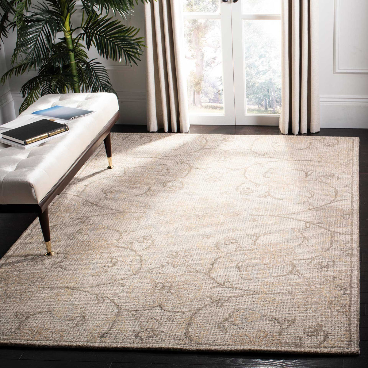 Light gray and ivory rug adds soft texture and floral scrollwork to a bright living area