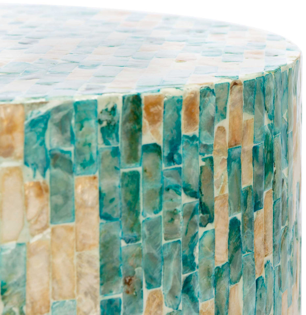 Variegated blue and gold shell tiles cover the tabletop and wrap around its rounded edge