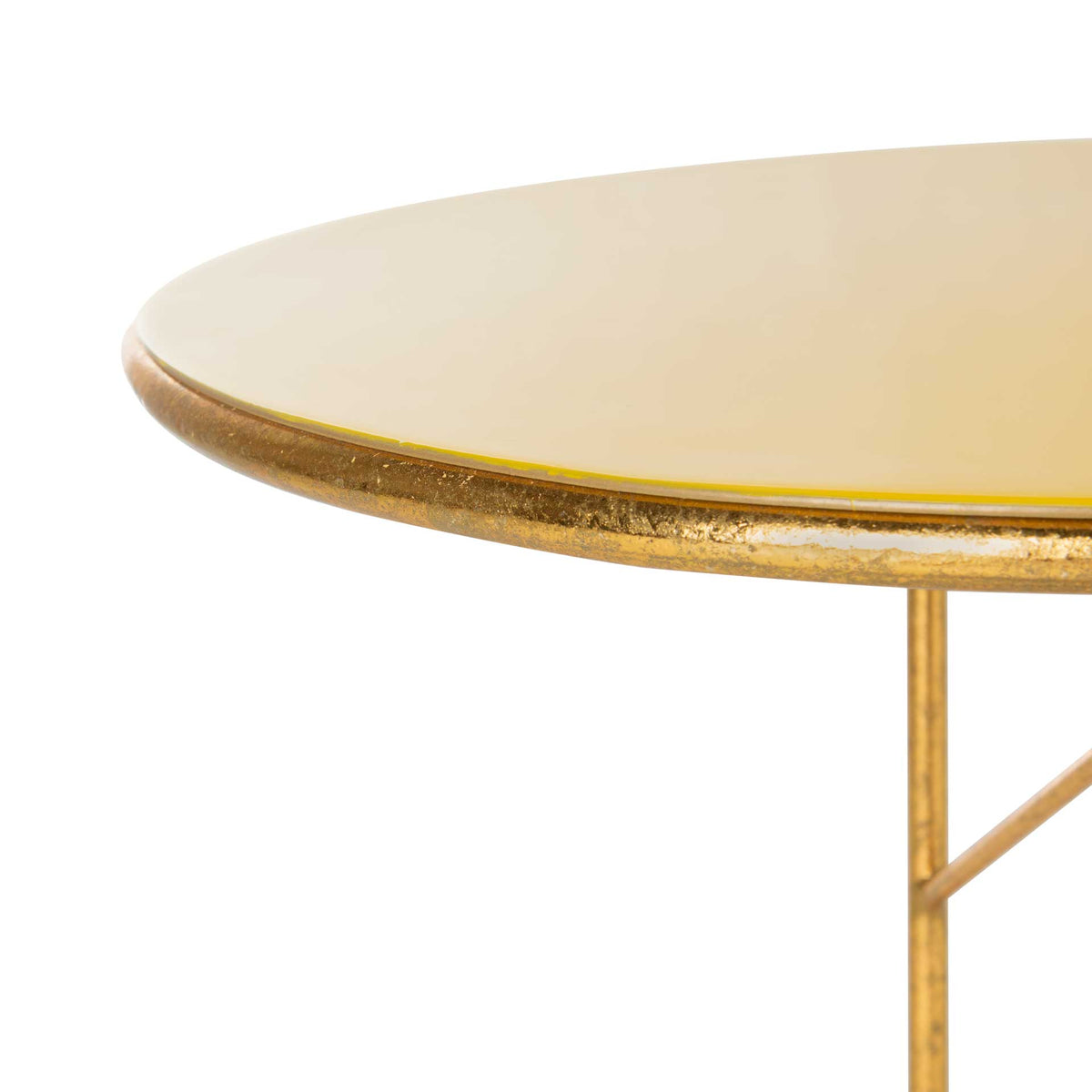 Smooth yellow enamel meets a textured gold edge along the tabletop's rounded rim.