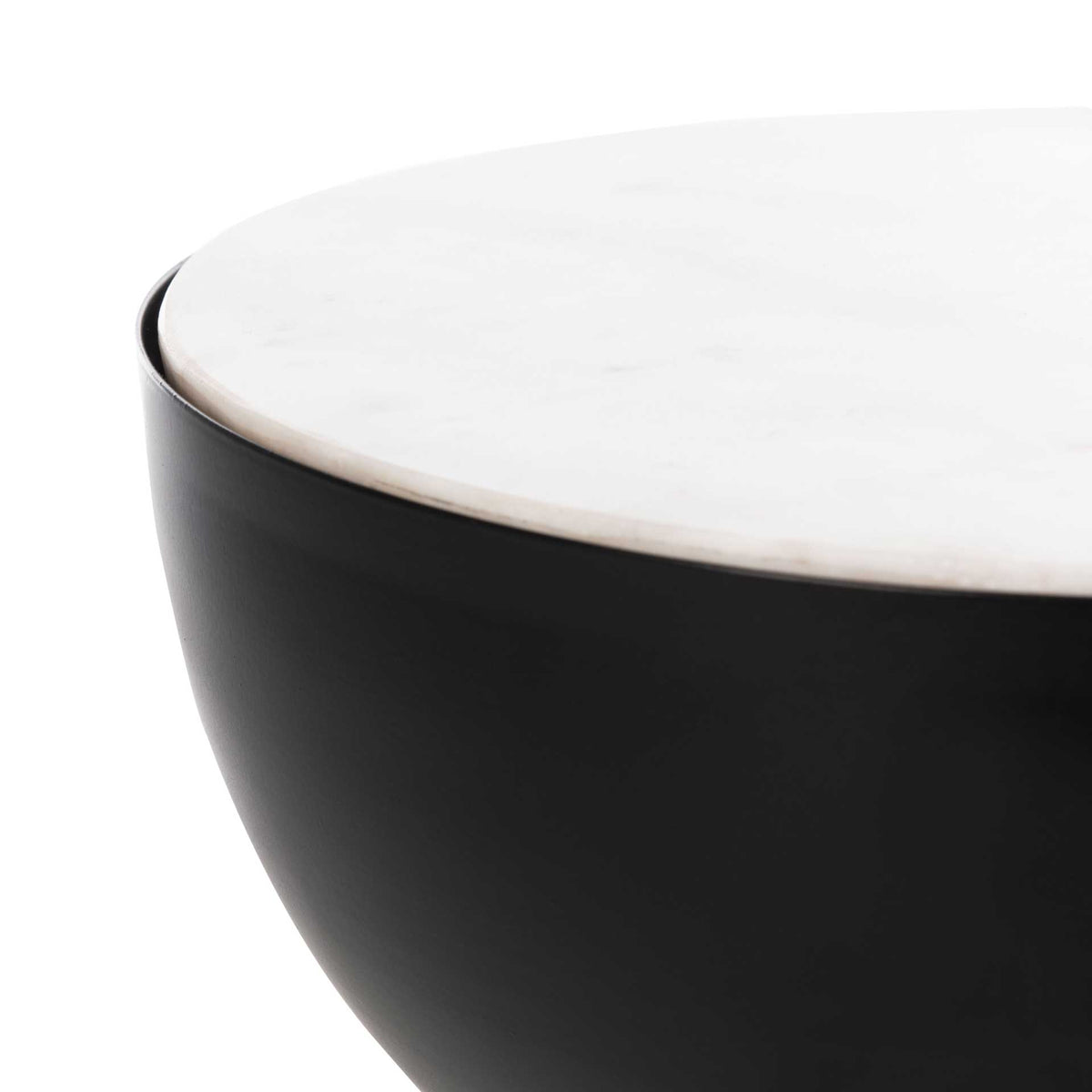 Smooth white marble meets the curved black metal beneath the tabletop