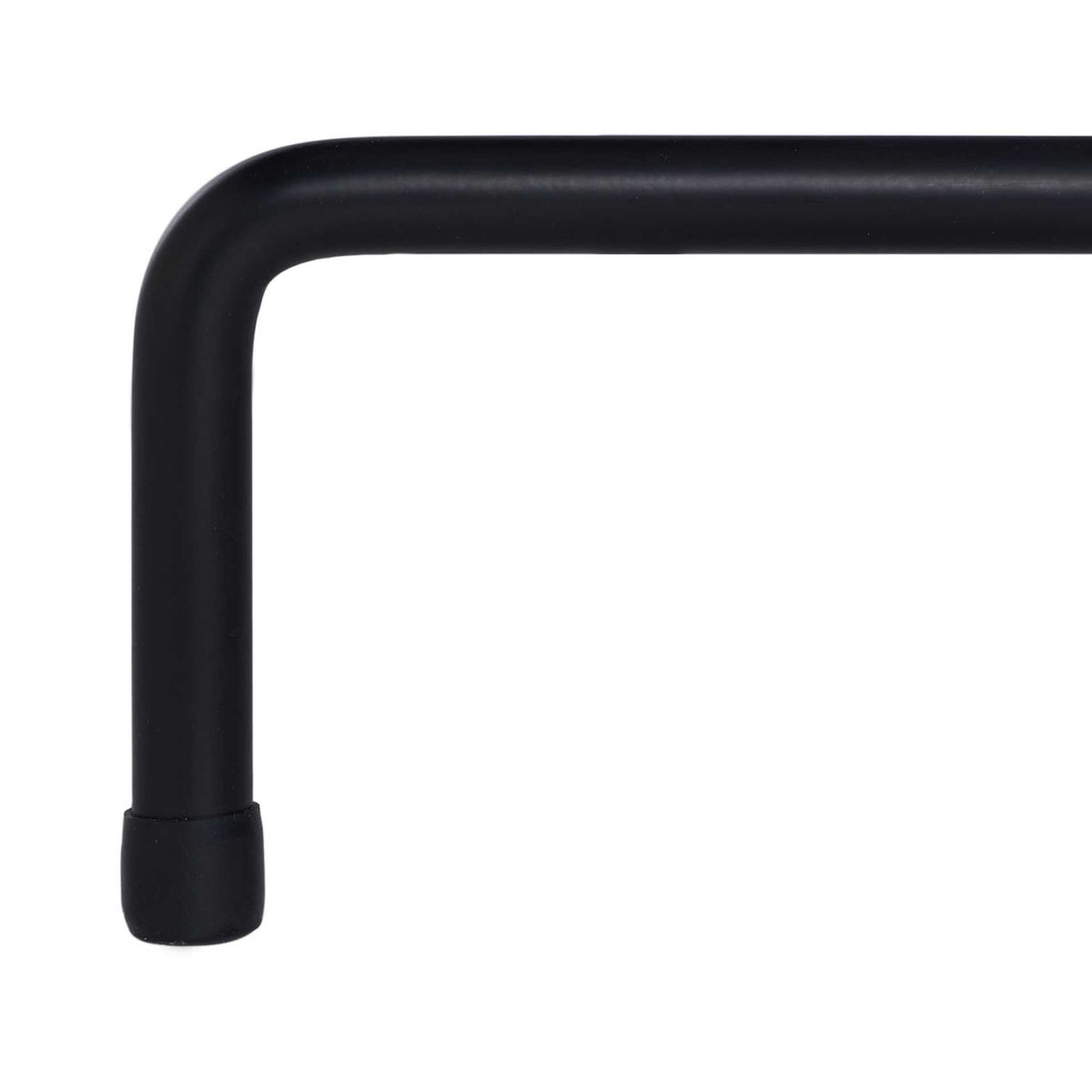 A black iron leg bends neatly down to a capped foot.