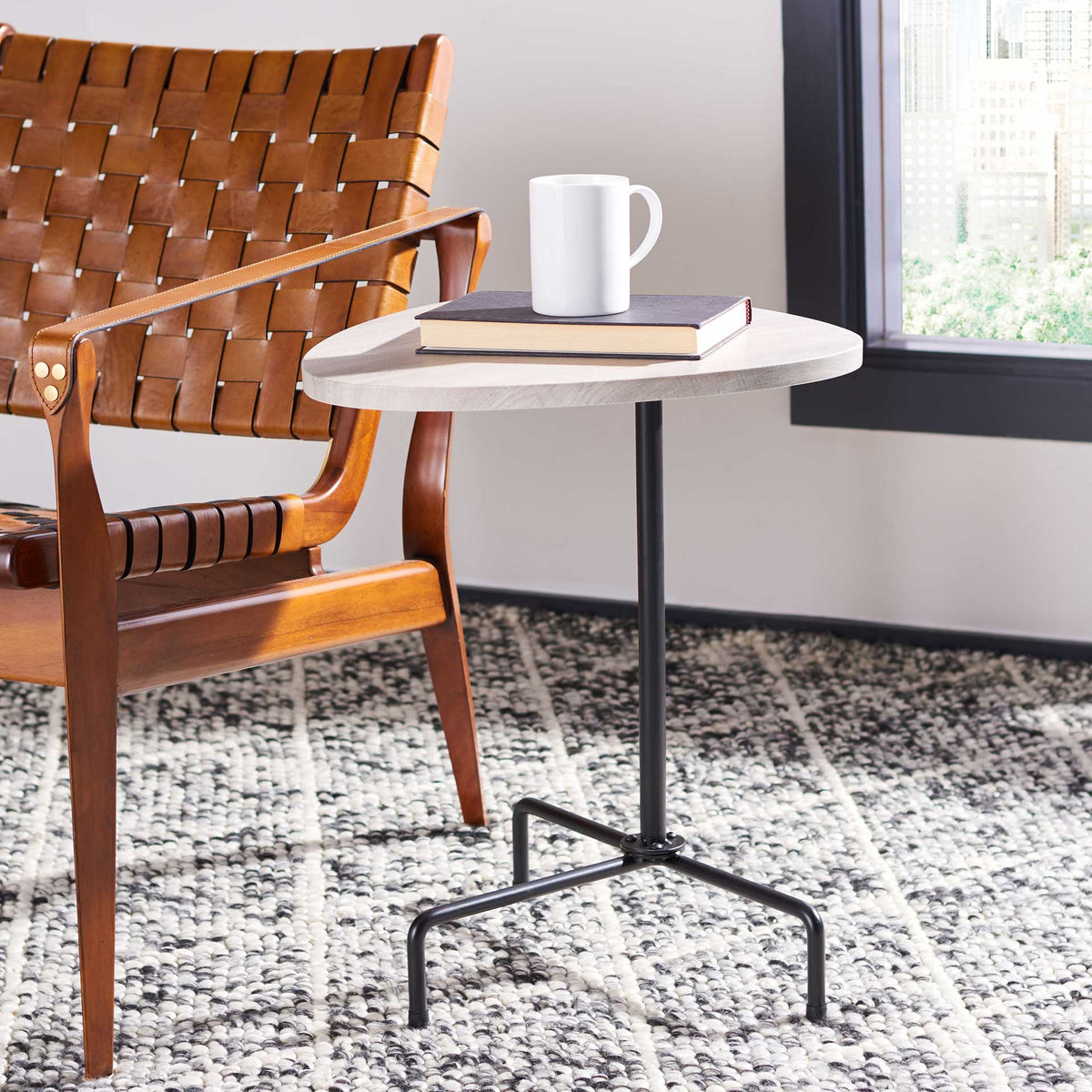 Pale gray oak tabletop offers a handy perch on slender black tripod legs.