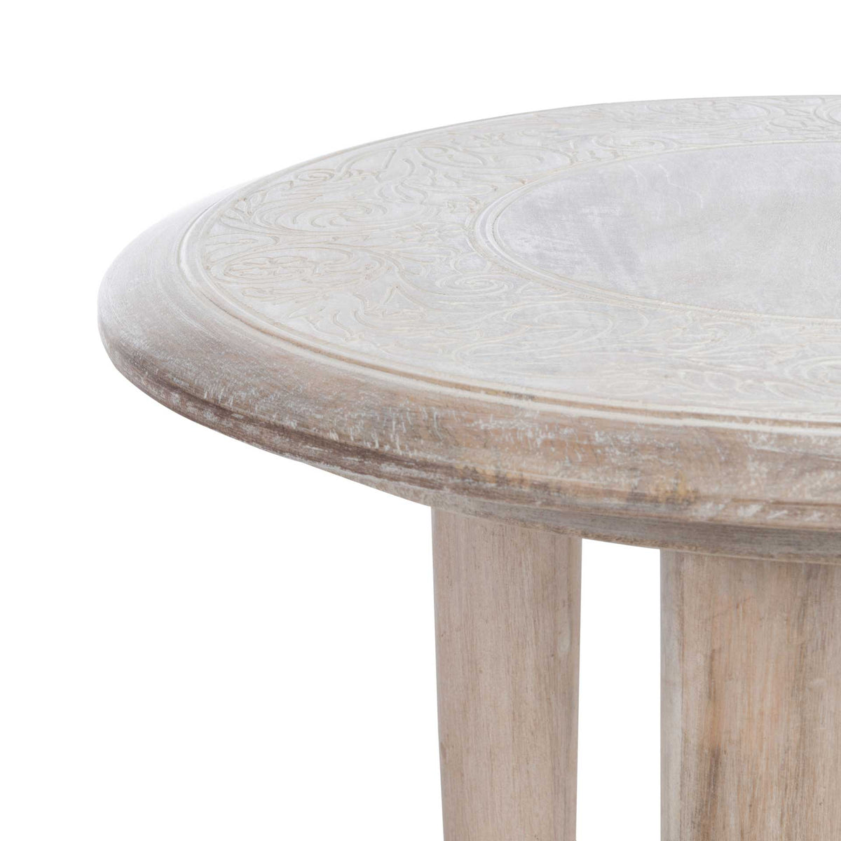 Fine carved flourishes and a gently rounded edge enrich the pale wood tabletop.