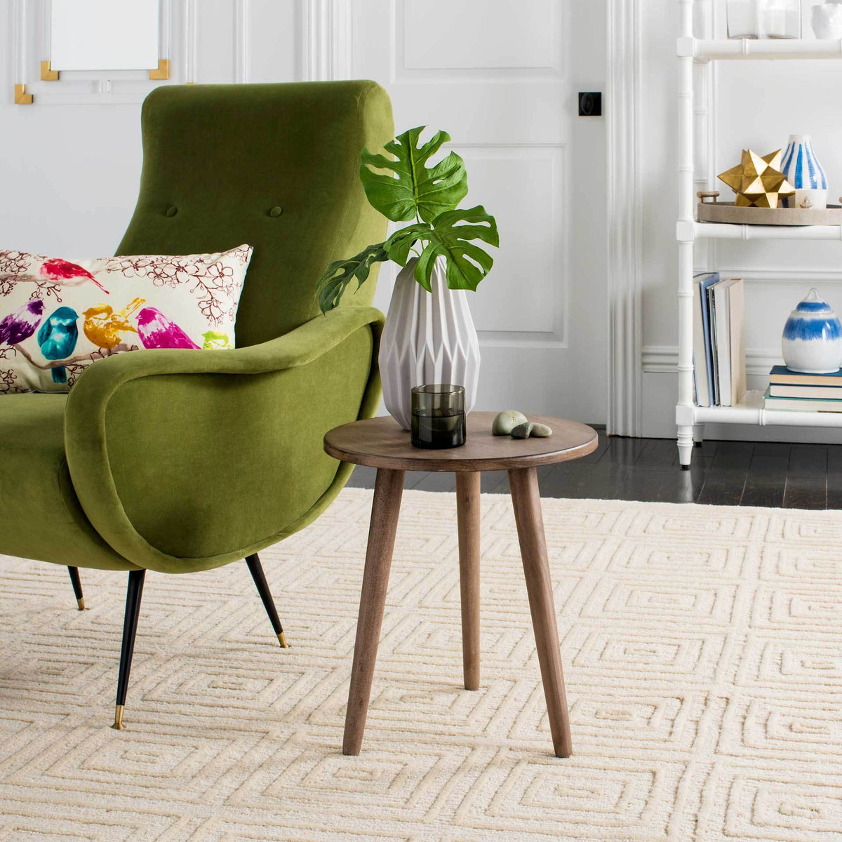 Compact light brown accent table with a round top and airy three-leg design