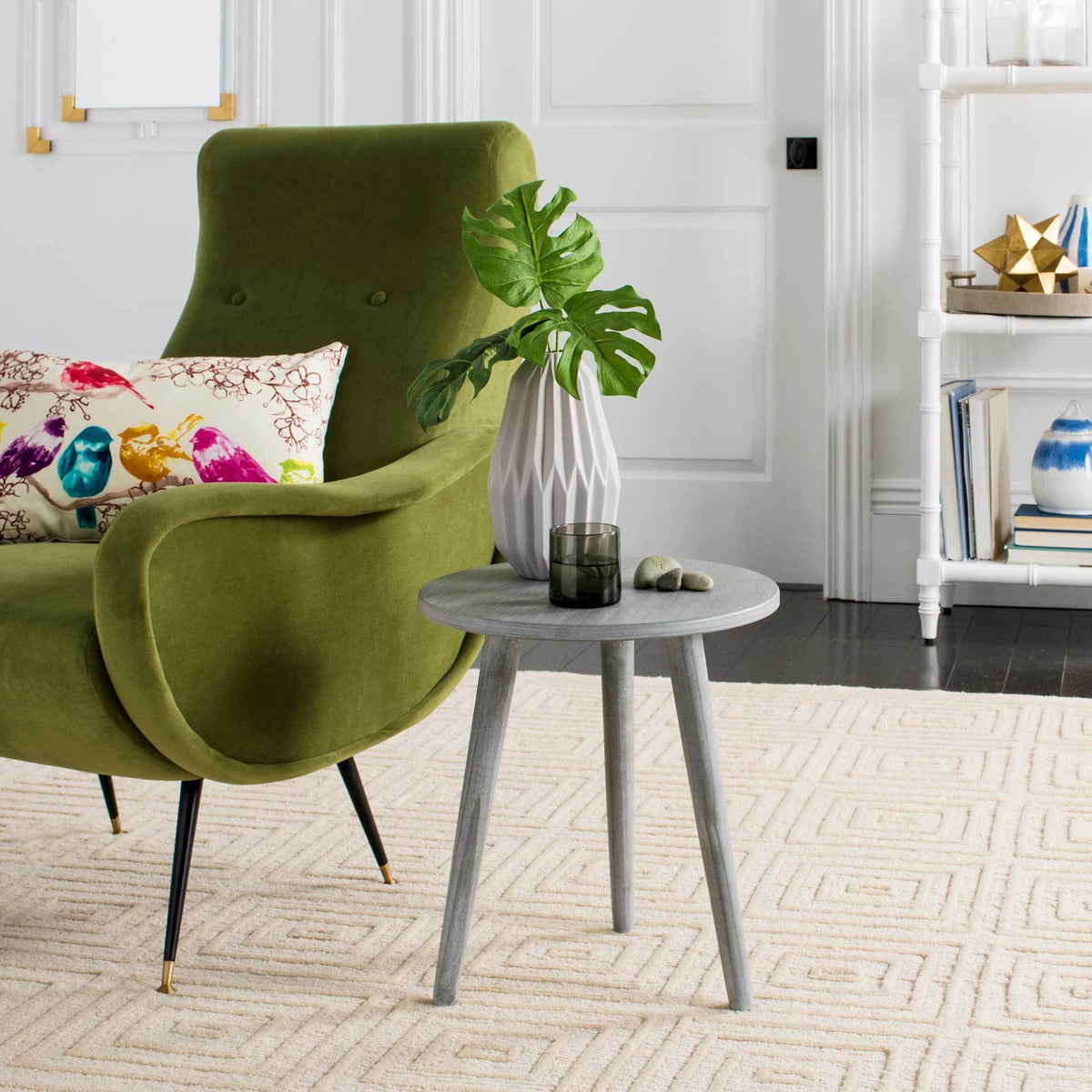 Compact gray wood accent table with a round top and splayed legs