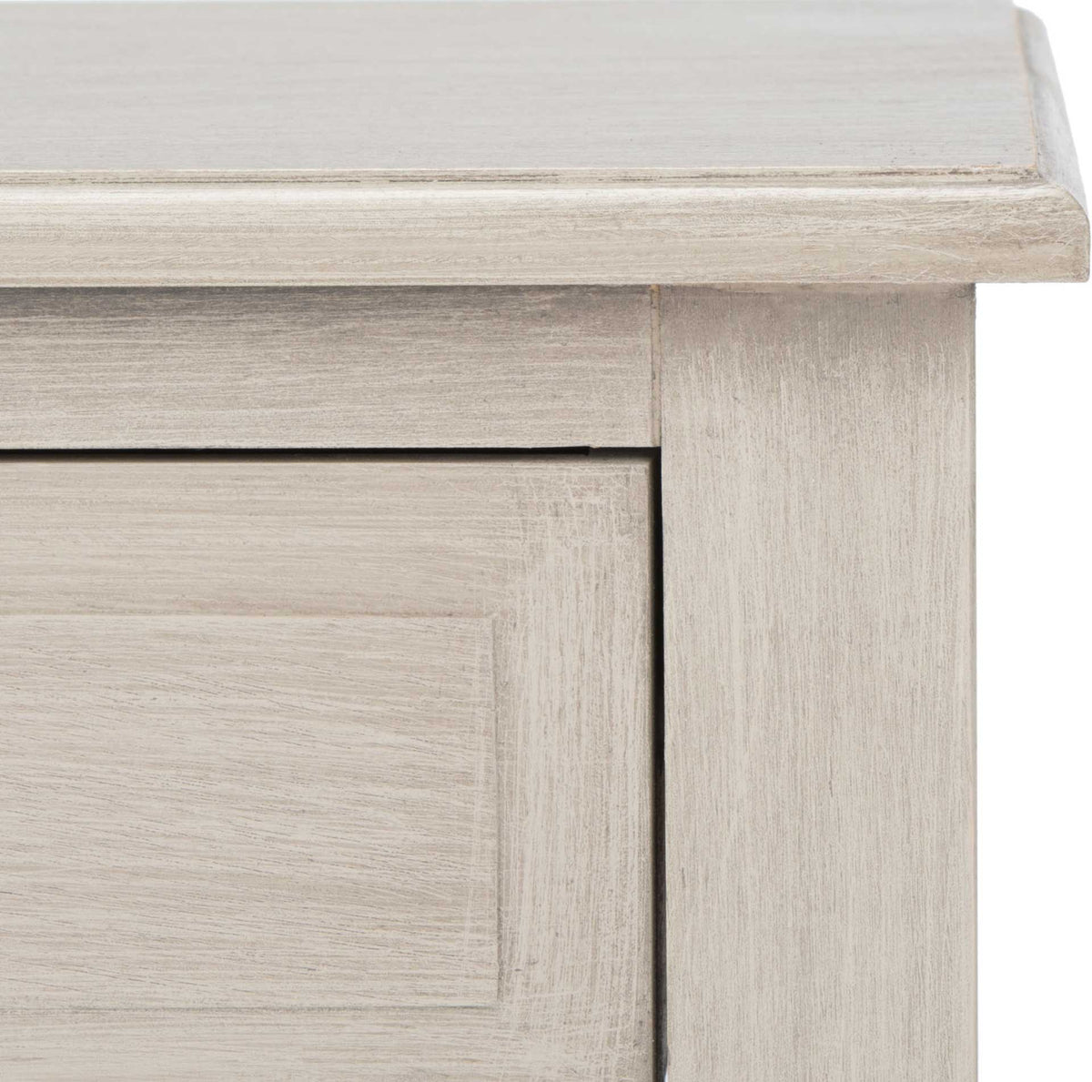 Weathered greige wood finish brings texture to the molded top and framed drawer