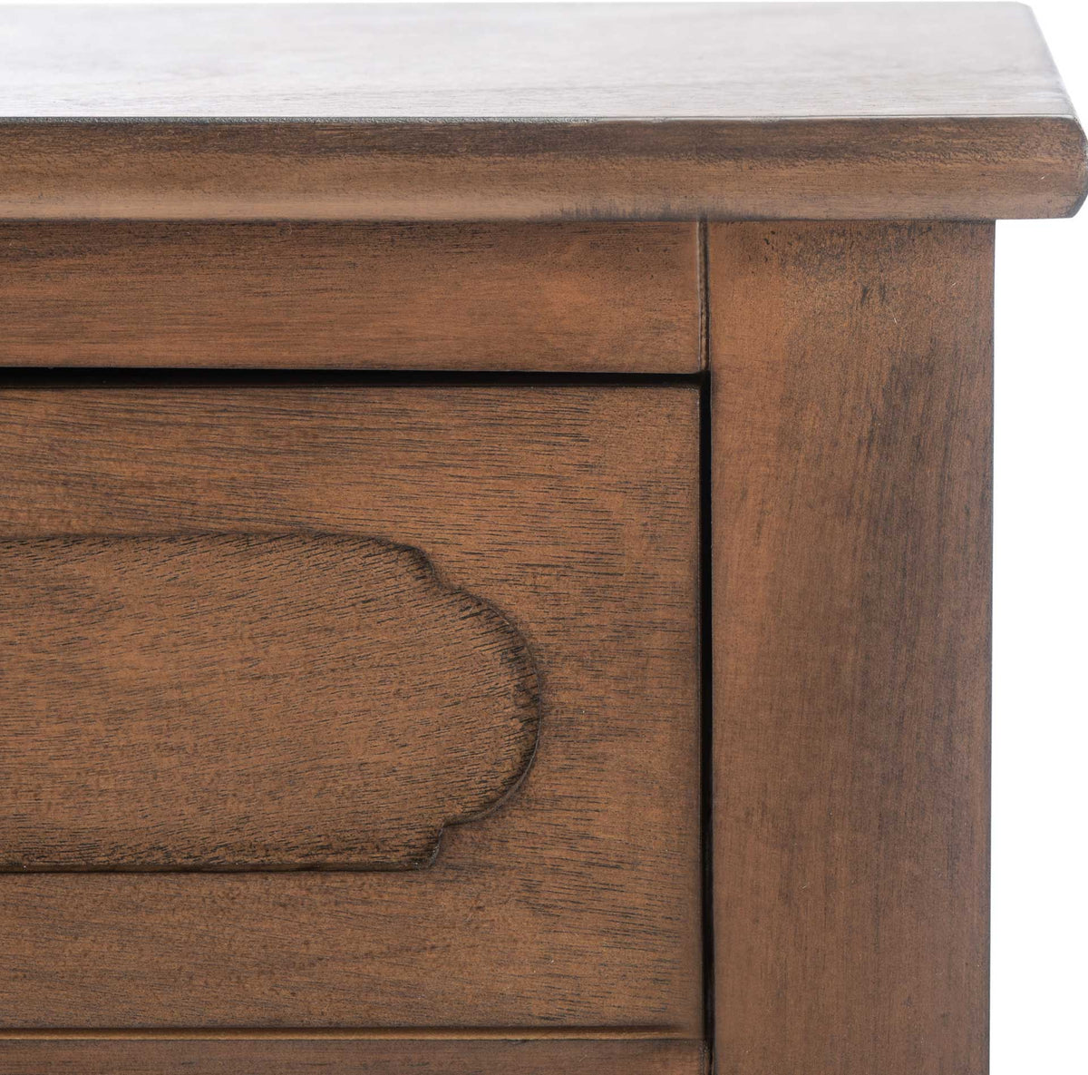 The rich brown finish brings out carved drawer trim and the softly beveled tabletop edge.
