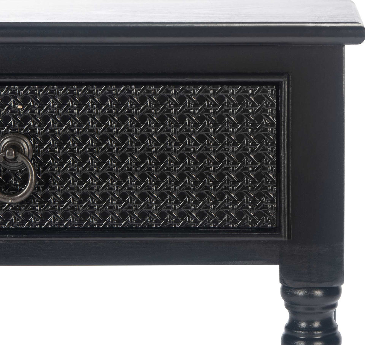 Intricate black texture fills the framed drawer front beneath a smooth, overhanging tabletop.