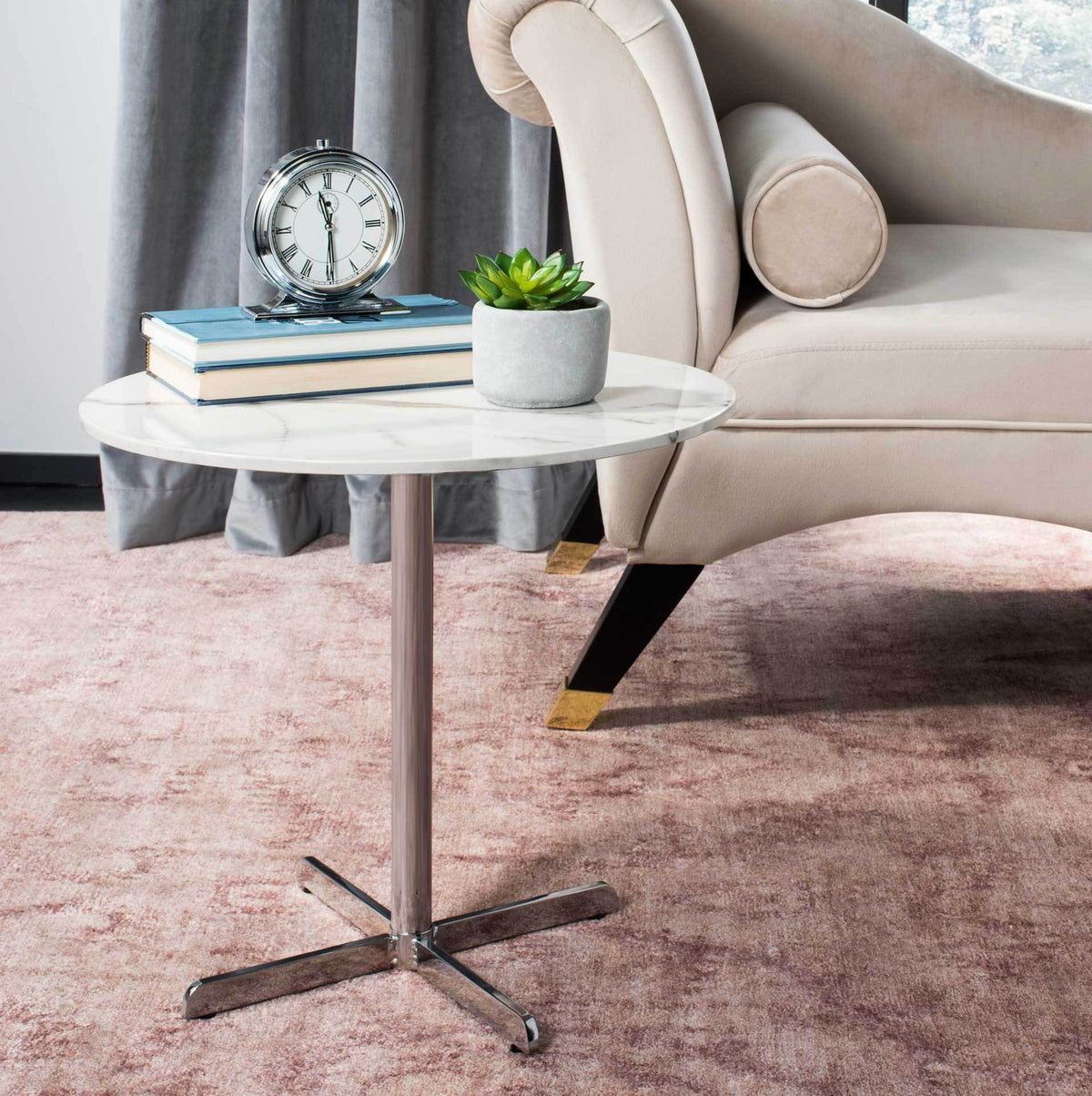 A white marble-look top and gleaming chrome base add a clean modern touch beside a chair.