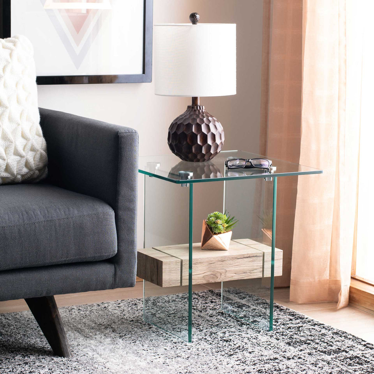 Warm, pale wood grain softens the crisp glass lines of this contemporary accent table.