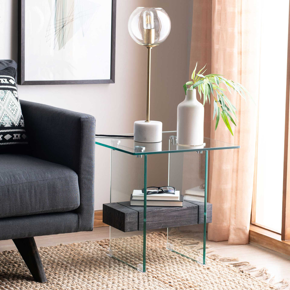 An airy glass accent table pairs a bold black shelf with clean, contemporary lines.