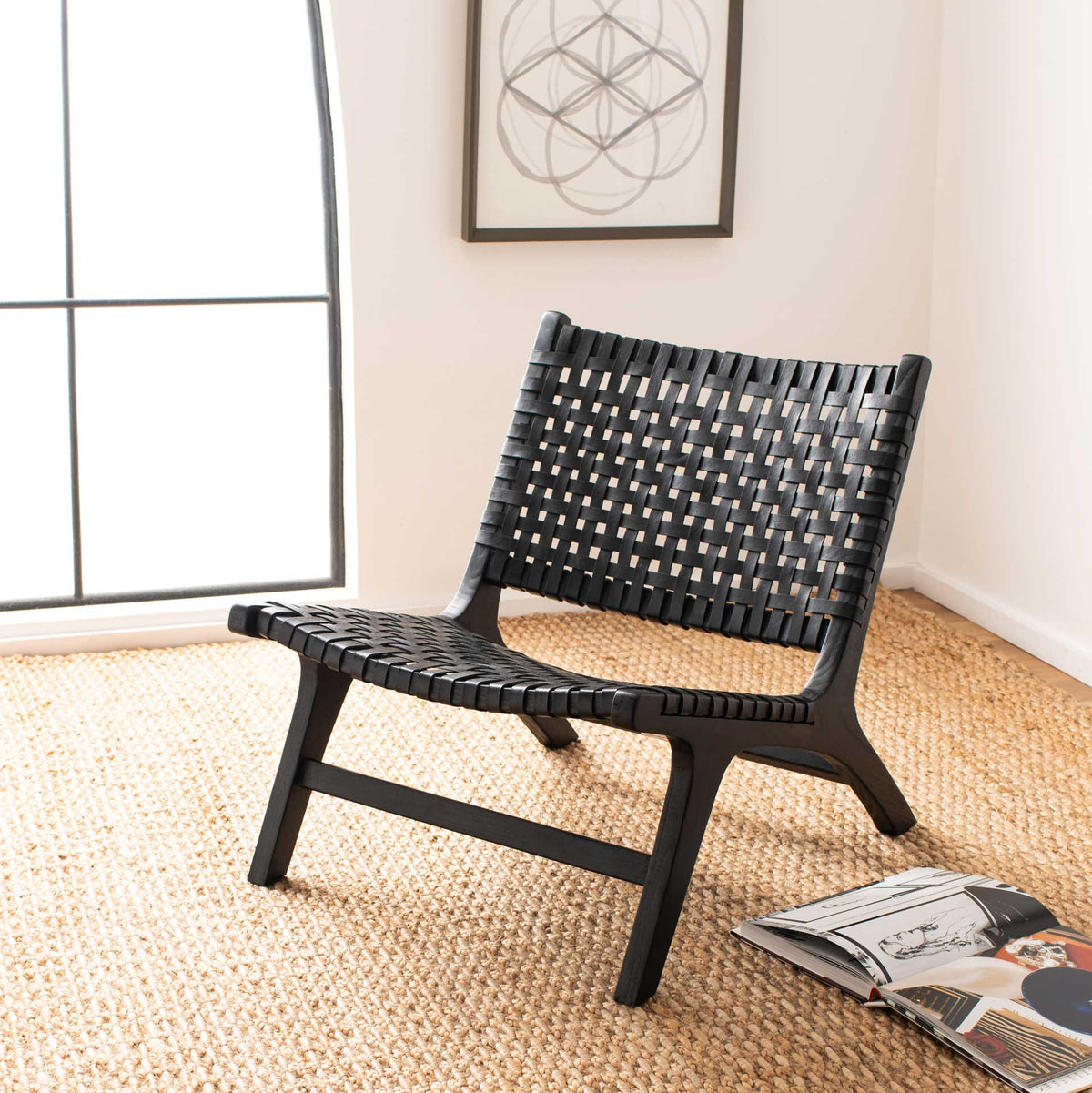 Black woven leather and a low wood frame bring graphic texture to a bright, relaxed room.