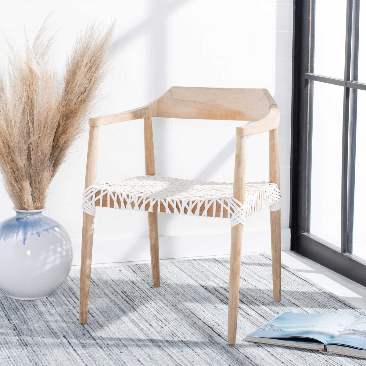 Natural teak and white woven leather add breezy texture to a relaxed seating nook