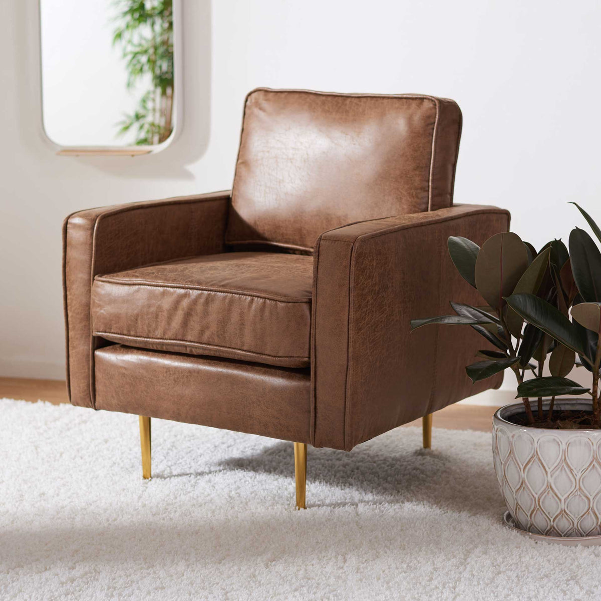 Plush brown cushions and sleek gold legs lend this accent chair warmth and modern elegance
