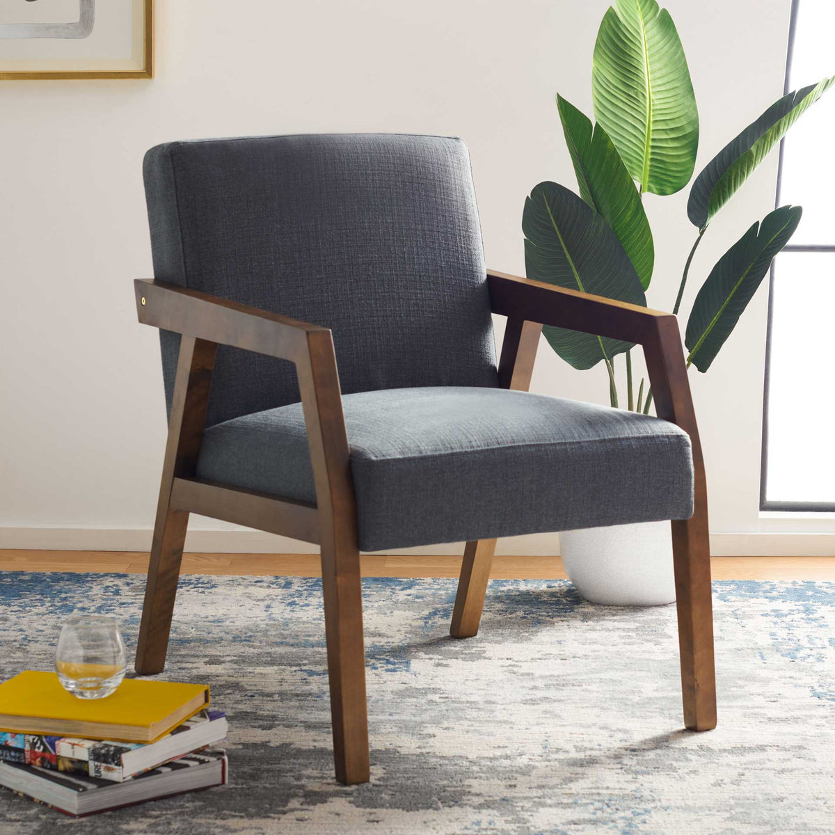 Generous dark gray cushions and open wood arms lend relaxed, modern comfort to a living space