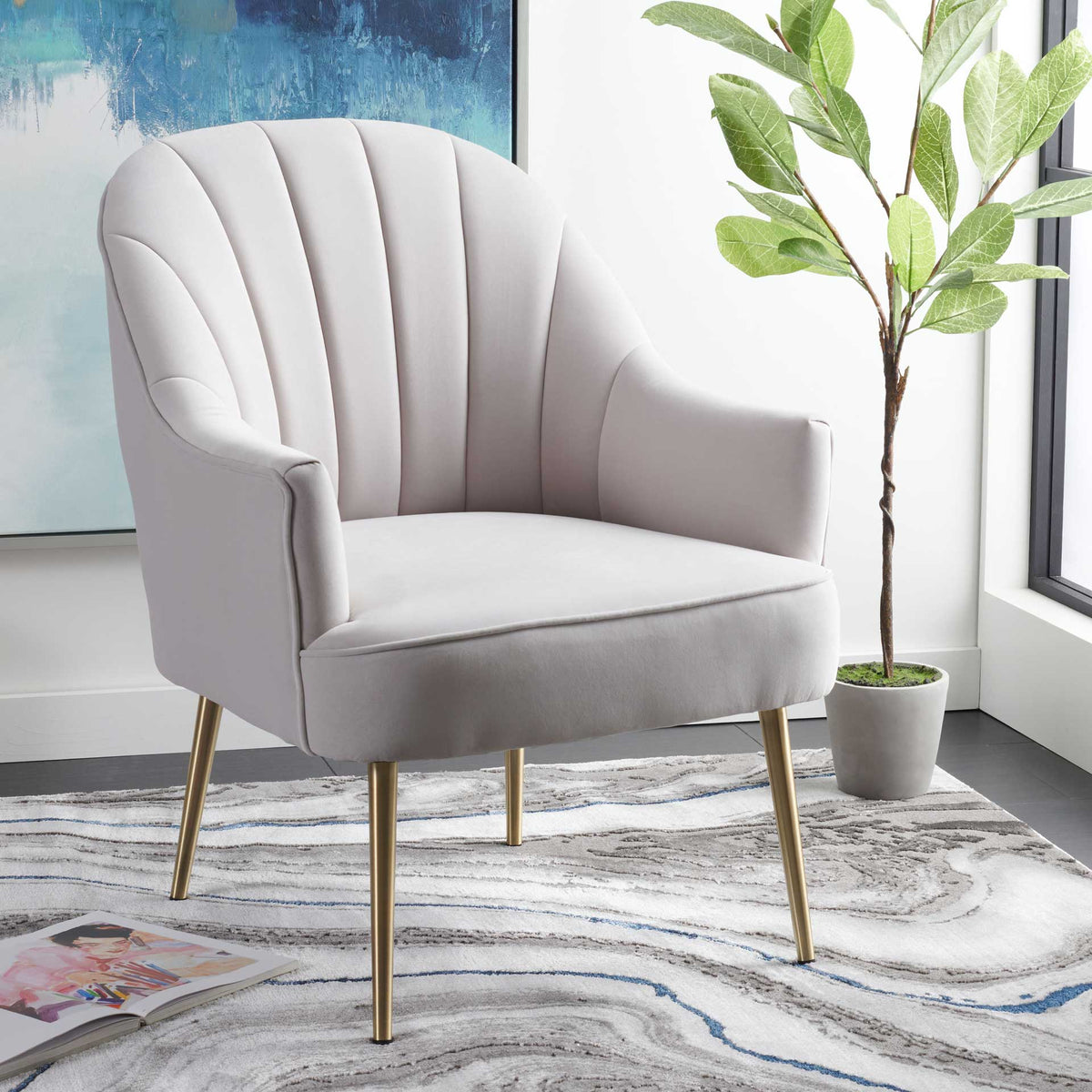 Sculpted arms and soft channel tufting give this light gray velvet chair an elegant Art Deco feel.