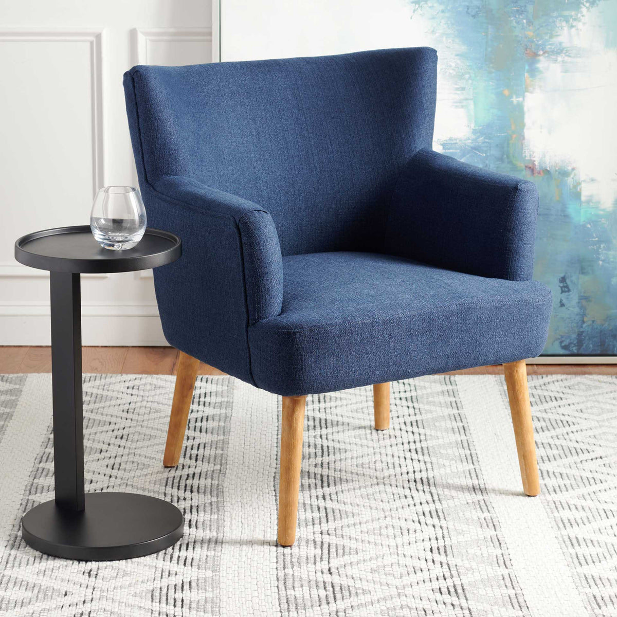 Deep navy accent chair adds color and comfort with textured fabric and a welcoming wingback
