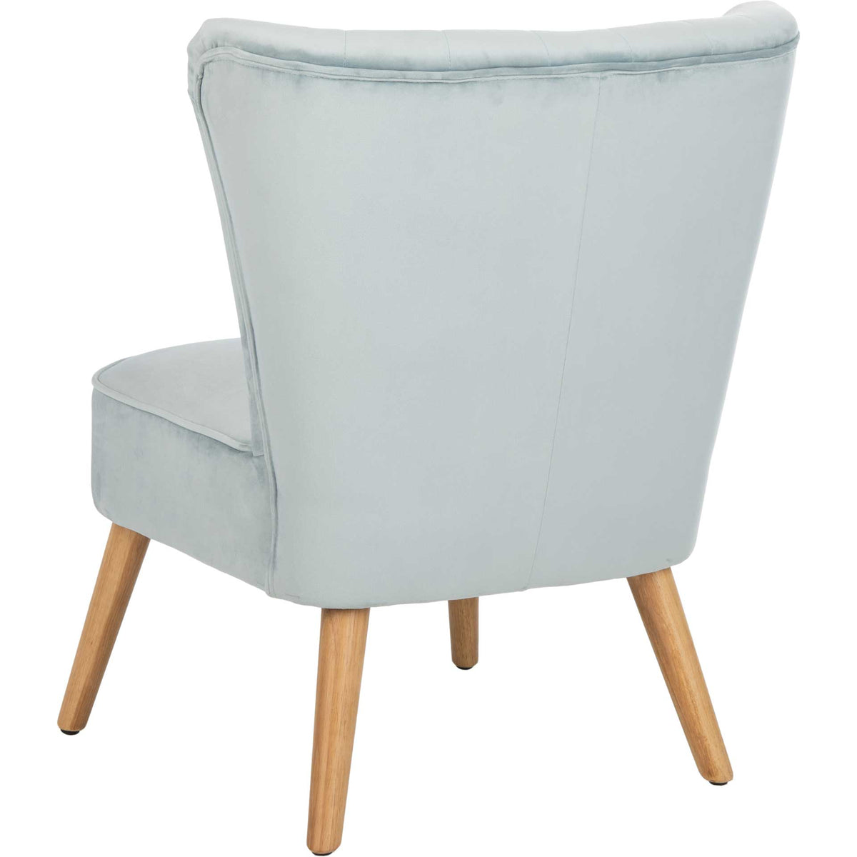 Pale slate blue velvet wraps the chair's wide, flared back and deep cushioned seat