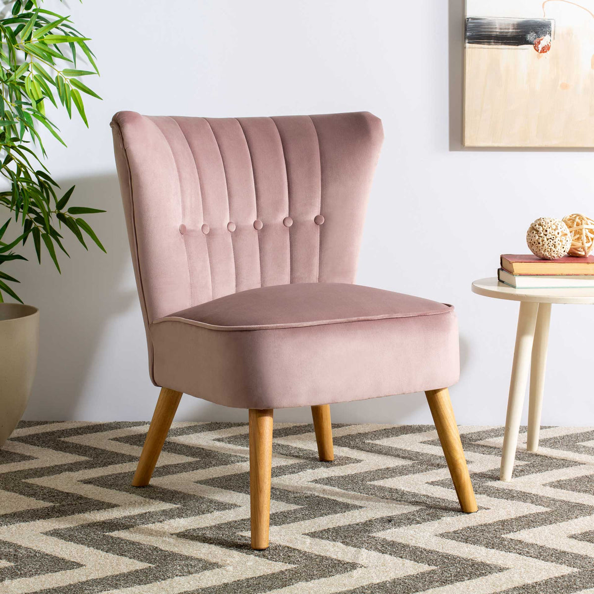 Muted mauve velvet and warm natural wood lend retro charm to this button-tufted accent chair