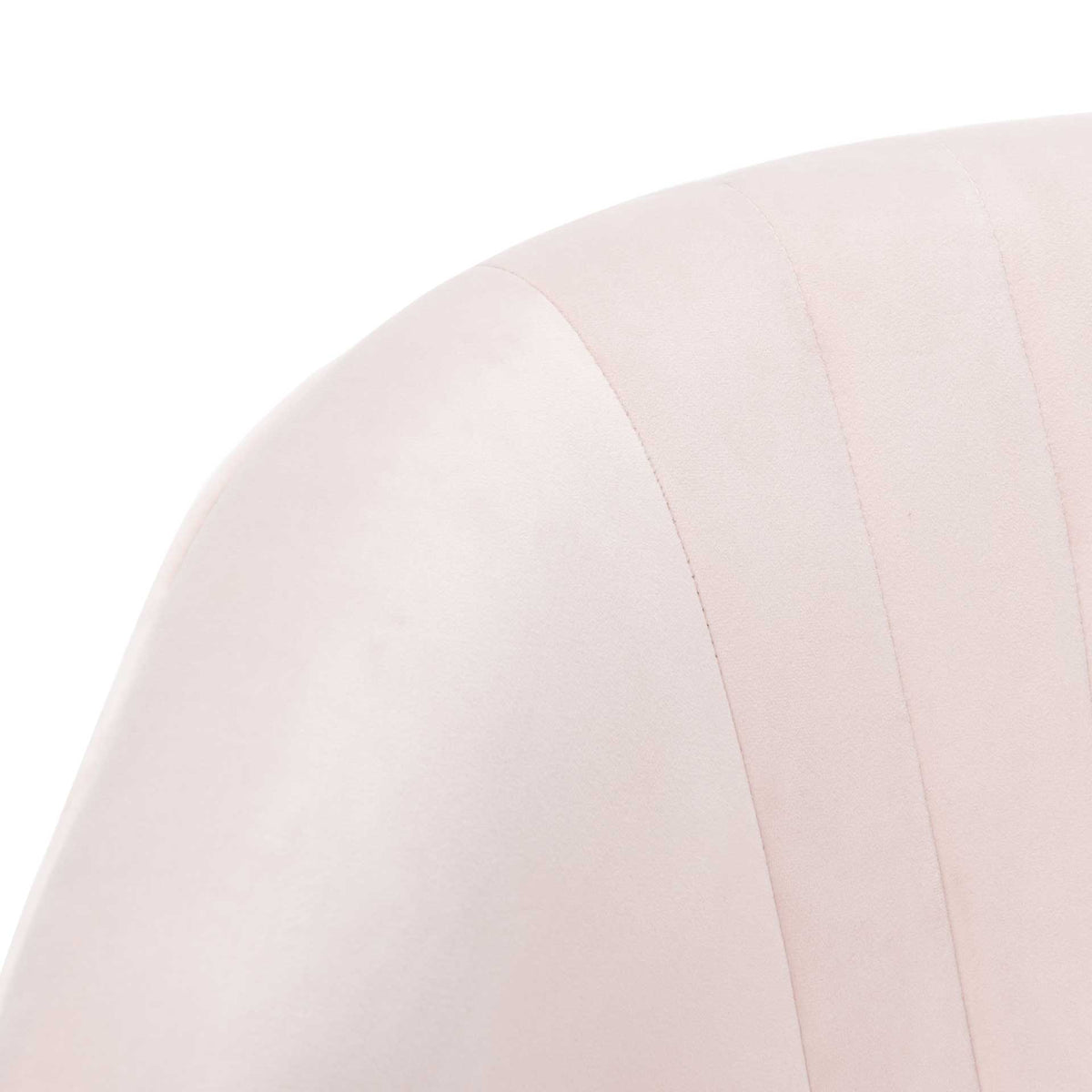 Delicate stitched channels add subtle texture to the softly rounded blush velvet upholstery.