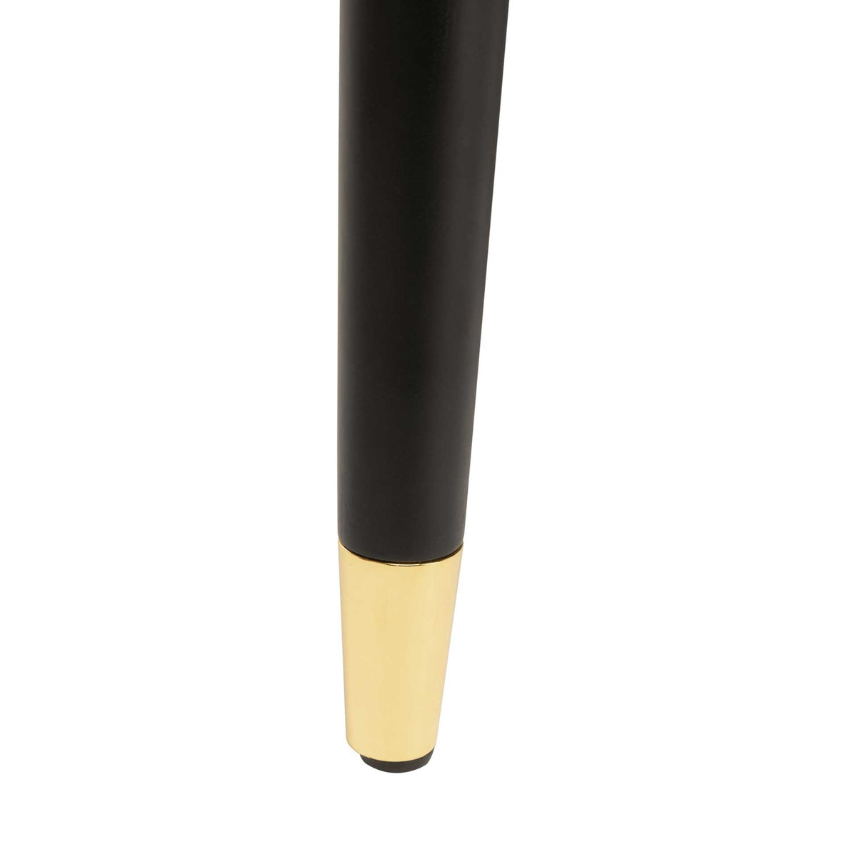 A slim black chair leg ends in a gleaming gold cap for a refined finishing touch.