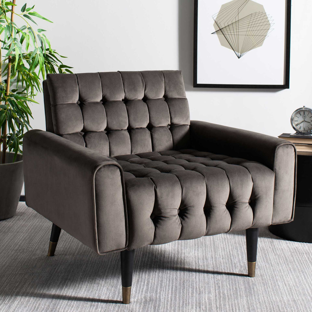 Tufted shale gray velvet and brass-tipped legs bring relaxed style to a living space.