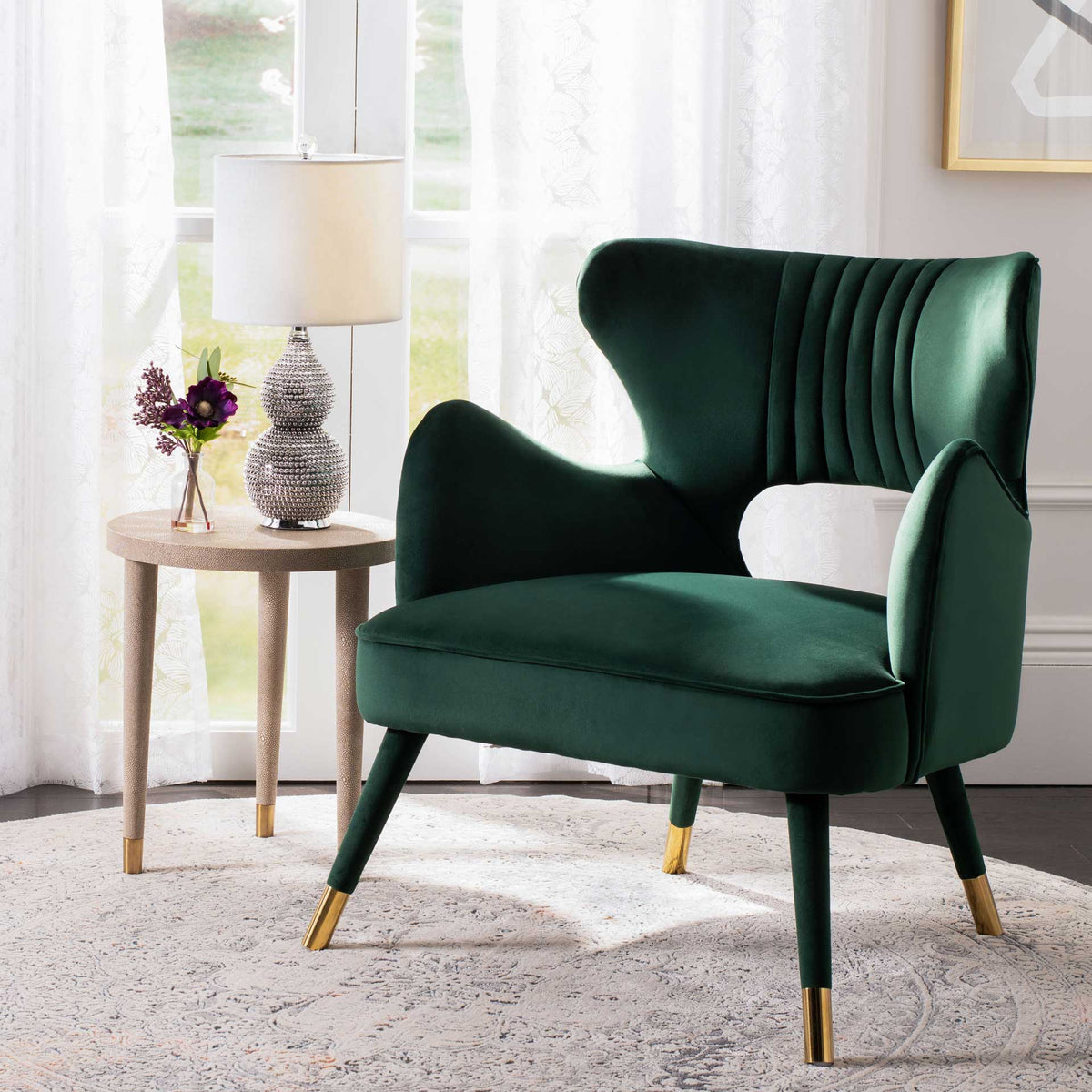 Deep green velvet, a channel-tufted back, and gleaming leg caps give this accent chair retro flair