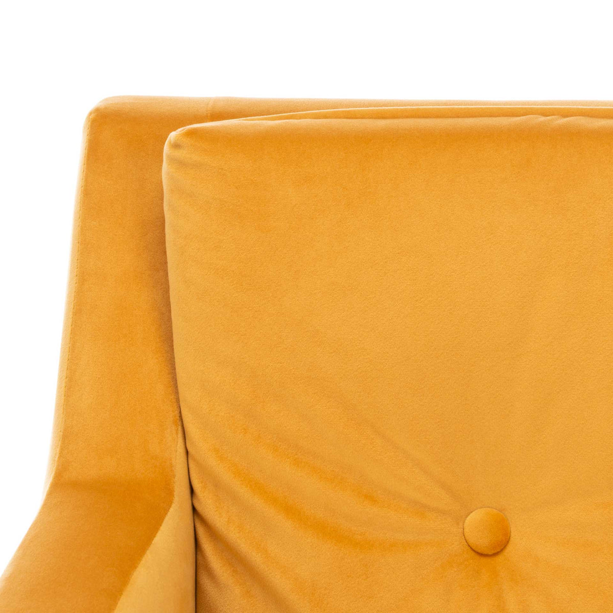 A fabric-covered button draws soft folds into the chair's rich marigold velvet back cushion.