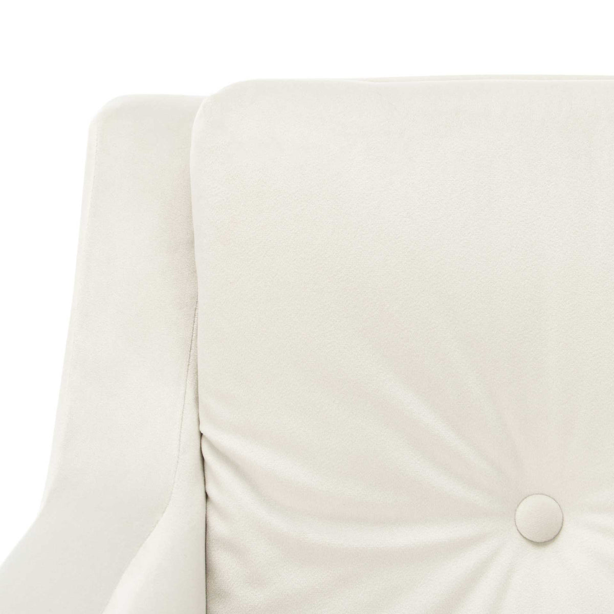 A covered button gathers soft folds across the chair's pale silver velvet back cushion.