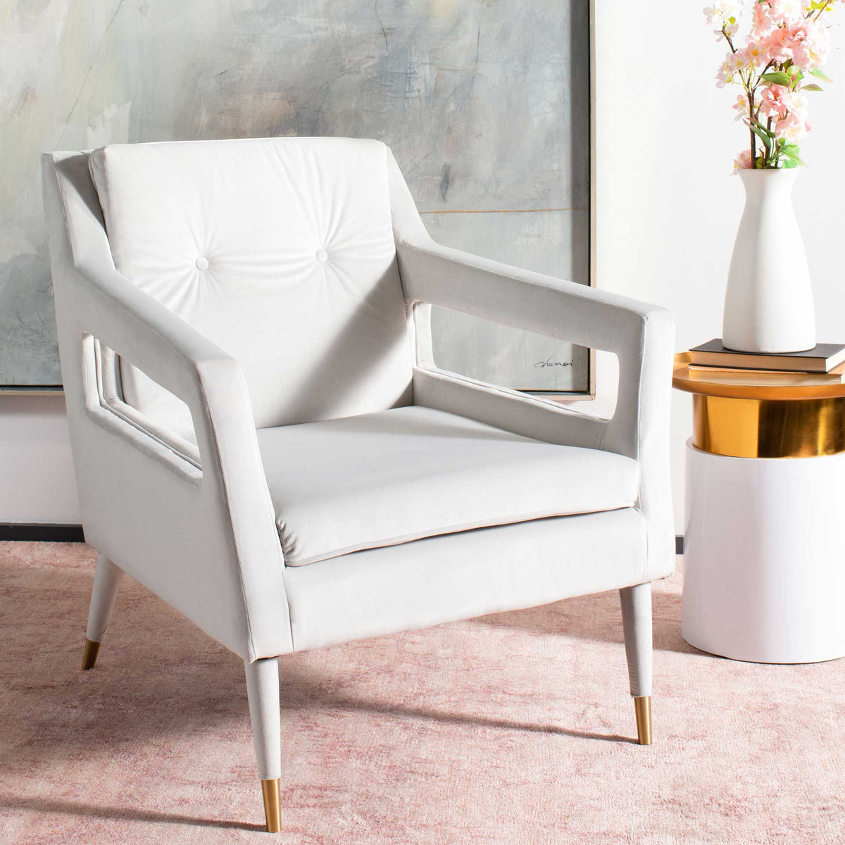 Pale silver velvet, button tufting and cutout arms bring soft elegance to this accent chair.