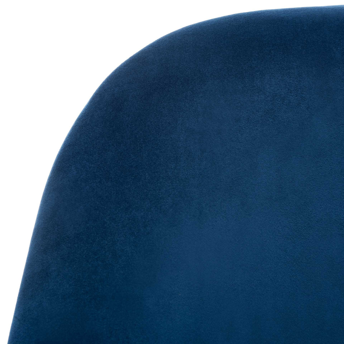 Rich navy velvet brings inviting texture to the chair's rounded upholstered back