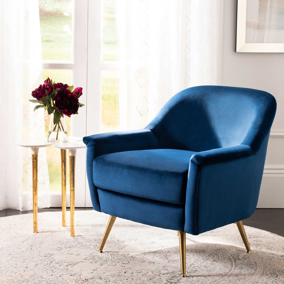 Deep navy velvet pairs with gleaming brass-tone legs for a bold yet cozy accent