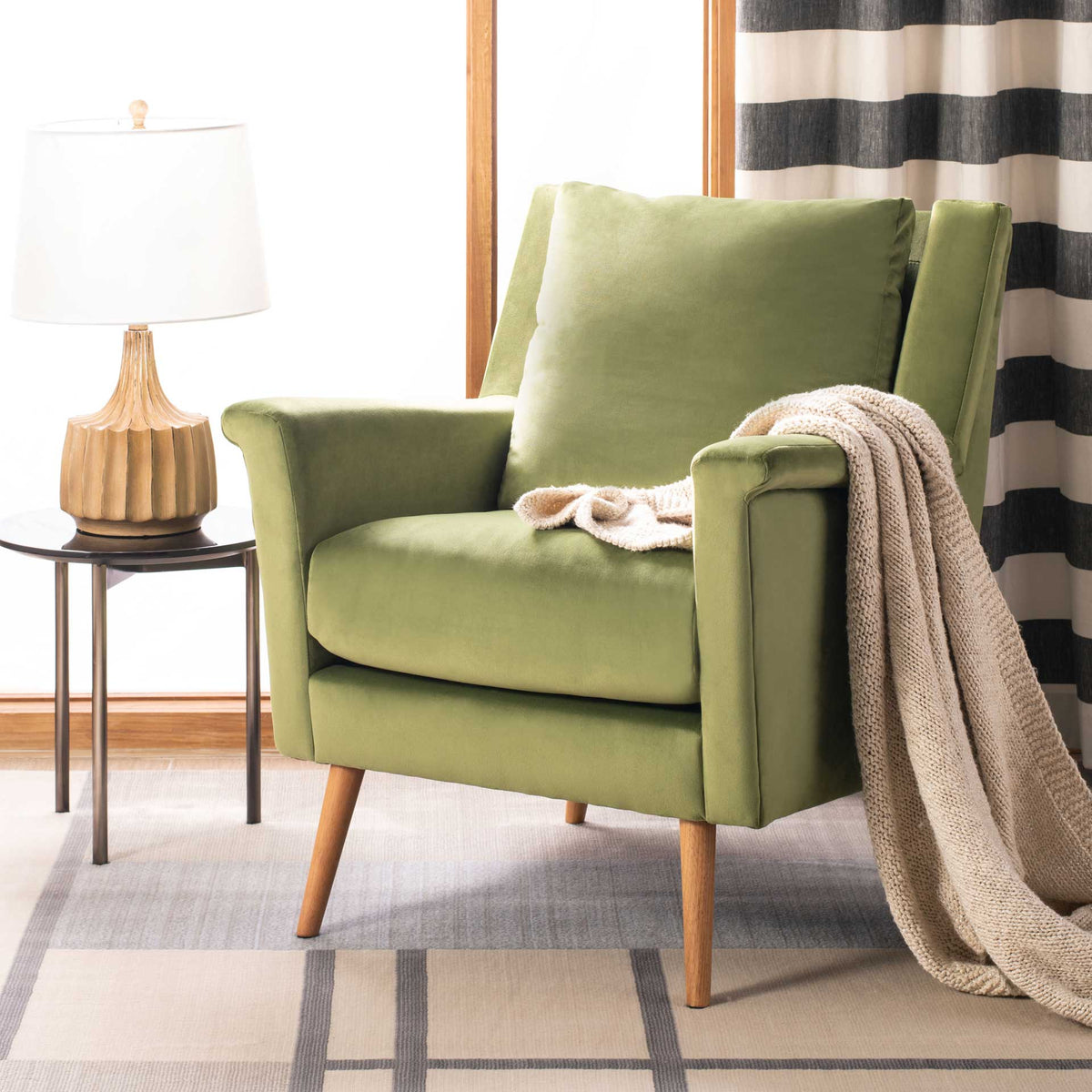 Olive velvet armchair lends earthy comfort with plush cushions and splayed wood legs
