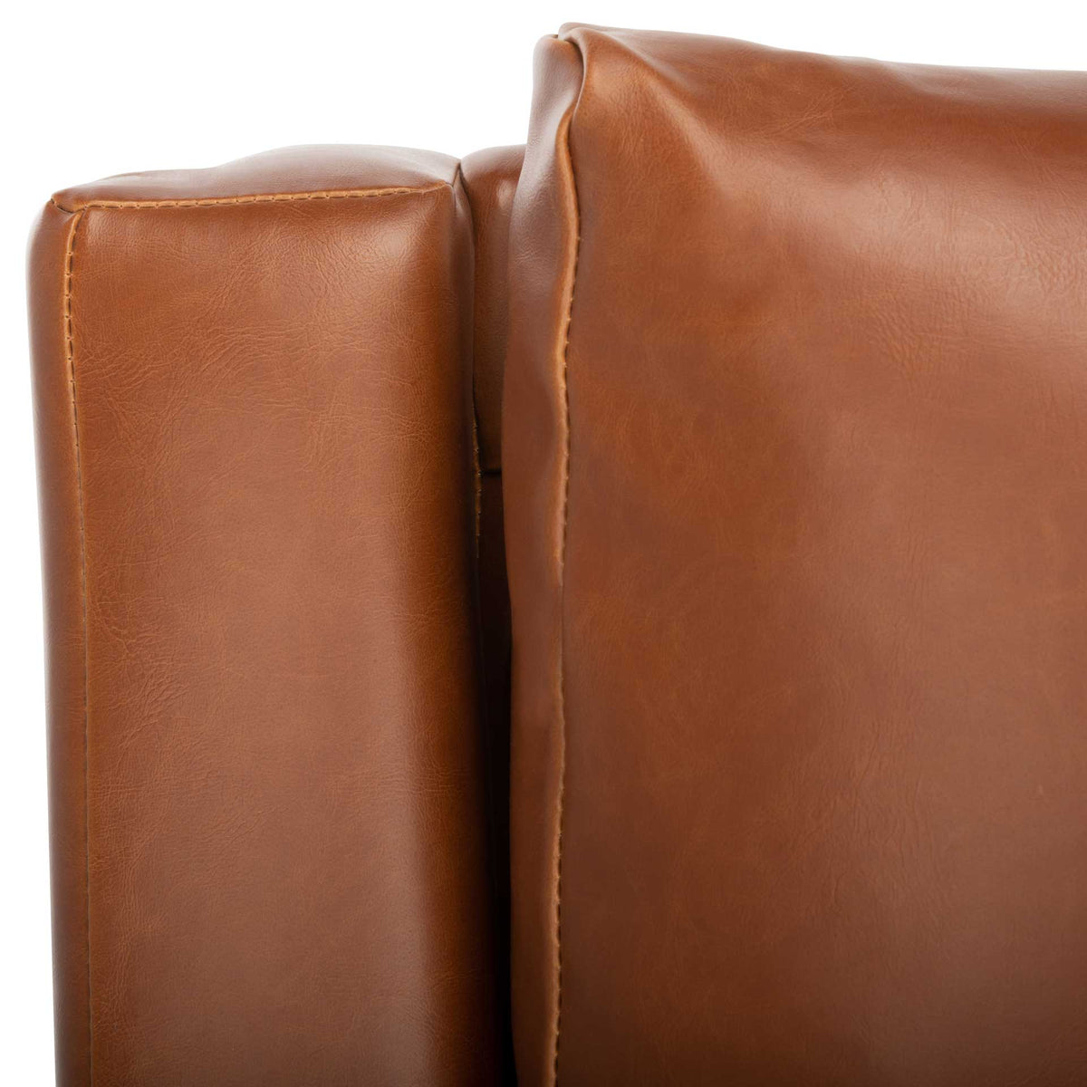 Stitched cognac faux leather defines the padded arm and generously cushioned back