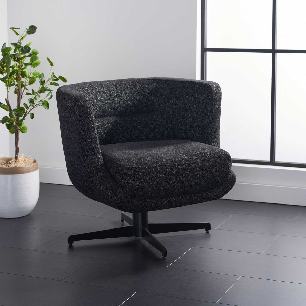 Curved black arms embrace a plush seat for cozy comfort on a modern swivel base.