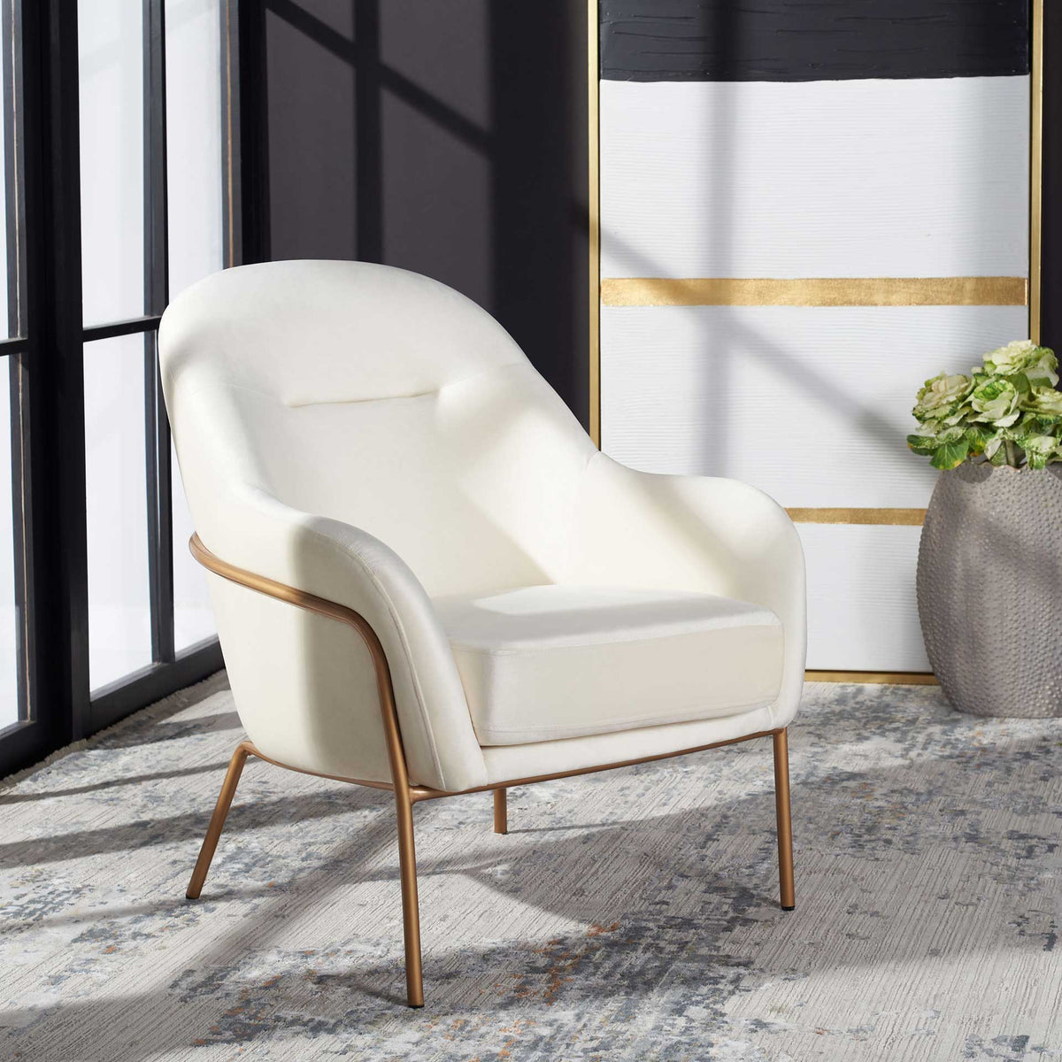 Cream velvet and a delicate gold frame add a soft touch to a modern living space.