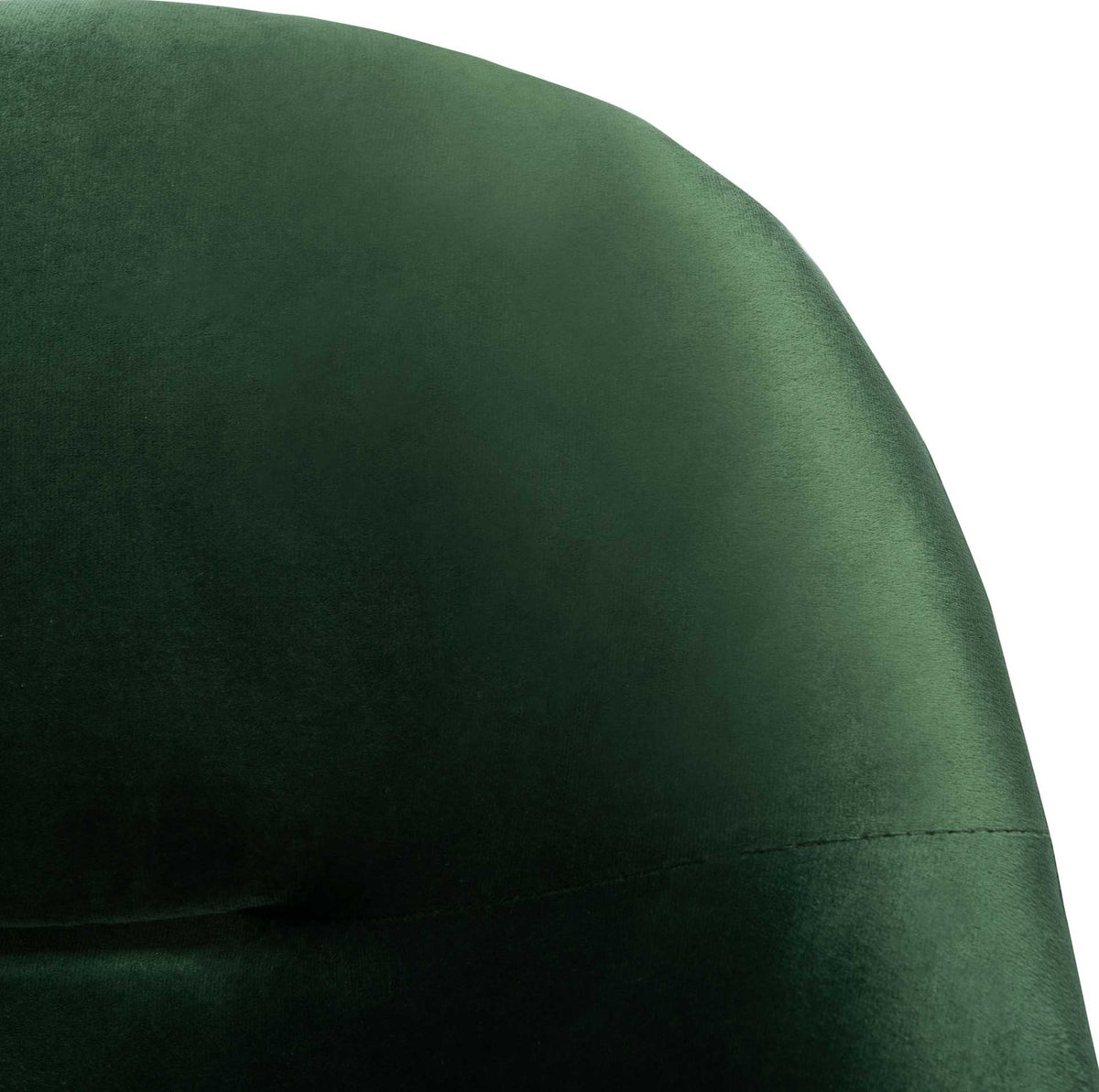 Dark green velvet glows softly along the rounded backrest and tailored seam.