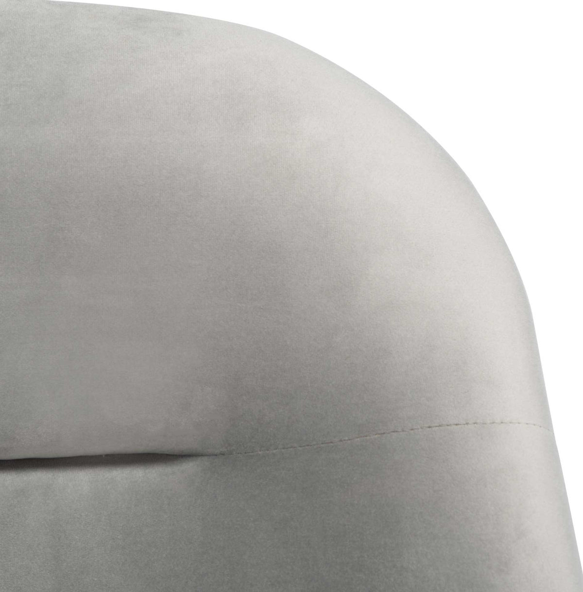Soft gray velvet lends subtle texture to the rounded, seamed backrest.