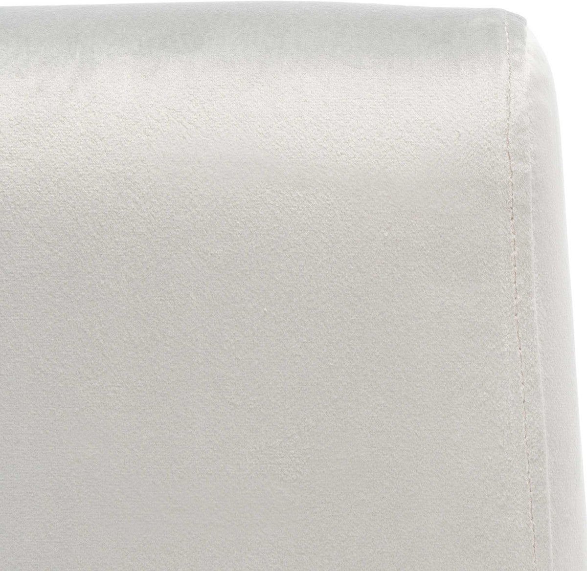 Soft gray velvet and a tidy stitched seam refine the cushioned backrest.