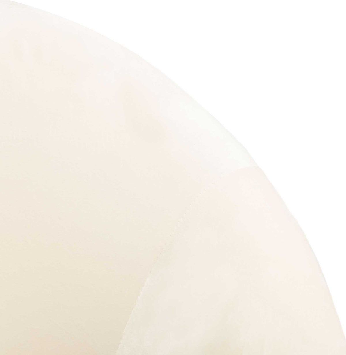 Soft cream velvet follows the arched backrest and gently rounded arm