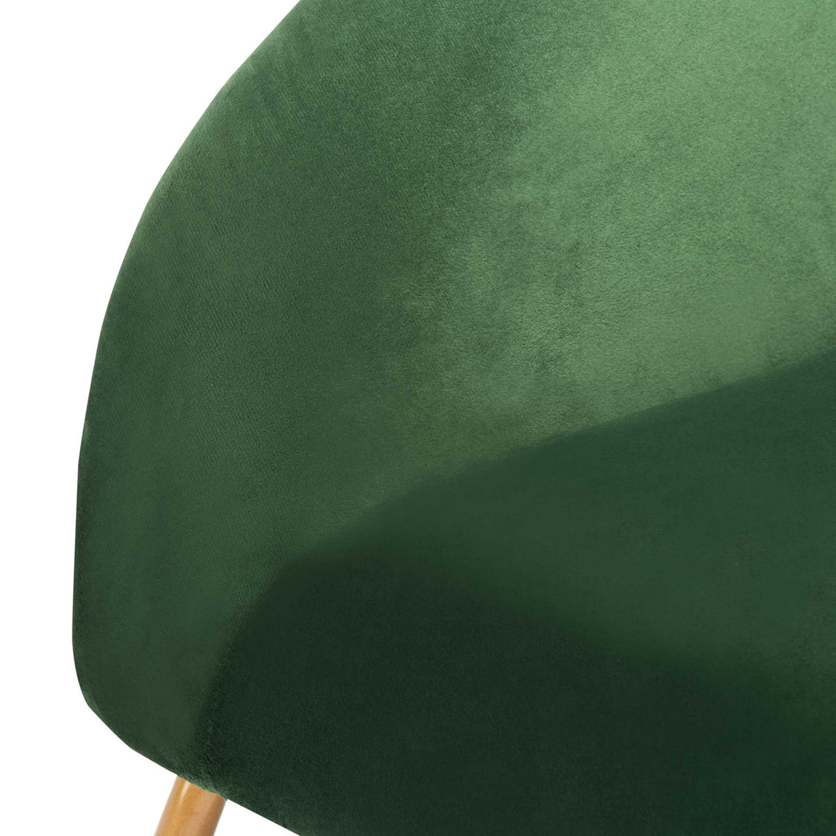 Deep green velvet flows from the rounded arm to the cushioned seat