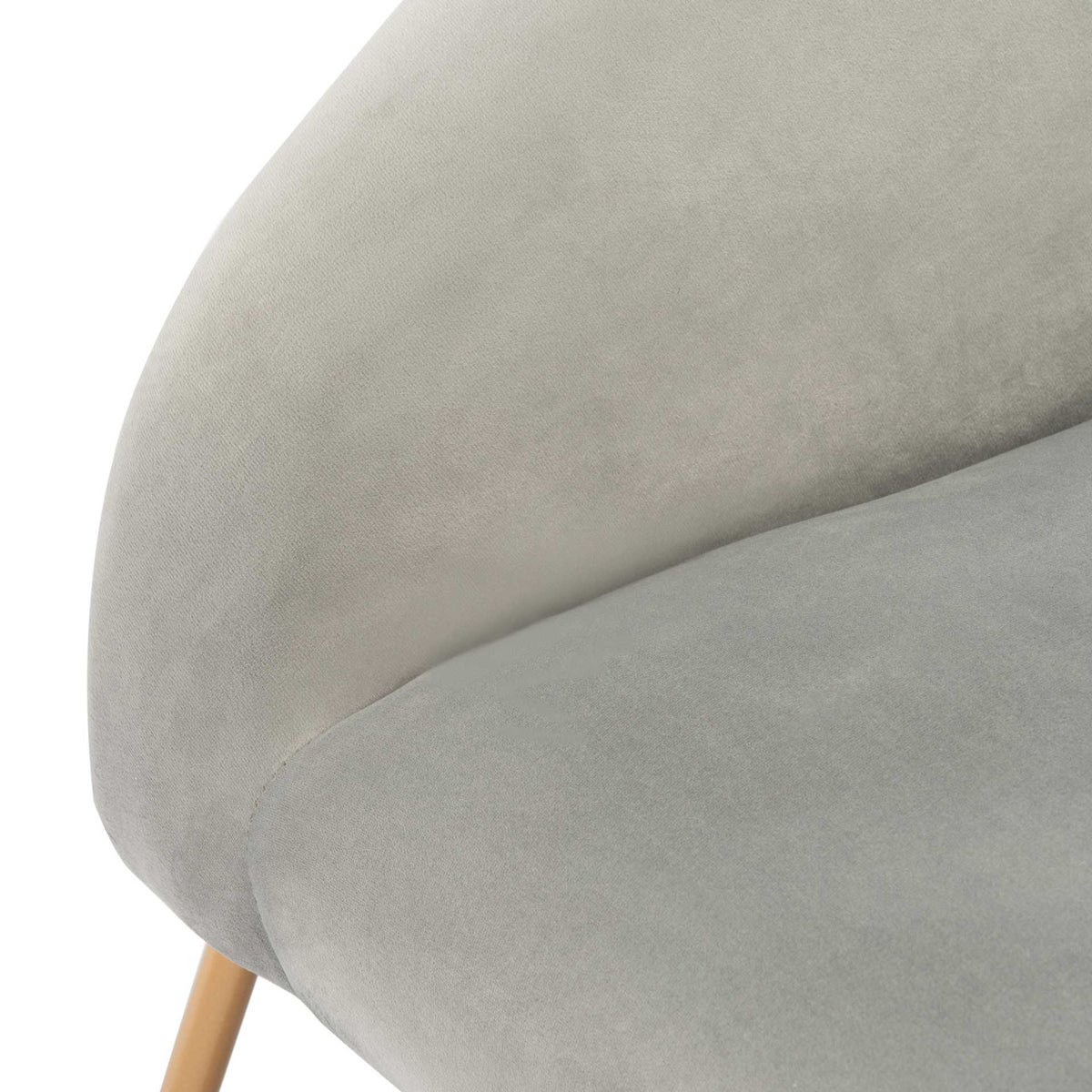Soft gray velvet covers the rounded arm and upholstered seat with a clean seam
