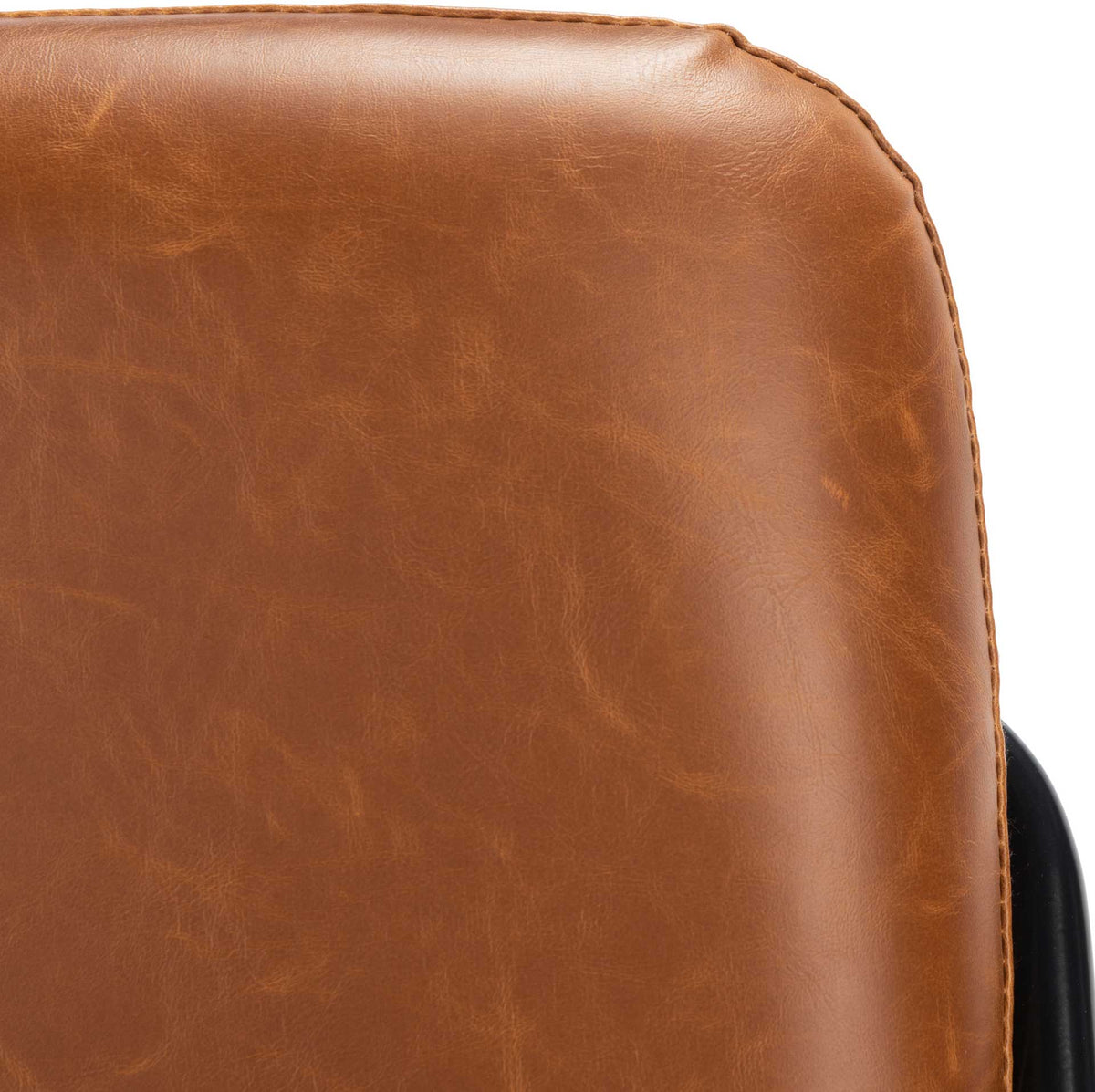 Subtle grain and stitched edging add texture to the warm brown faux leather upholstery