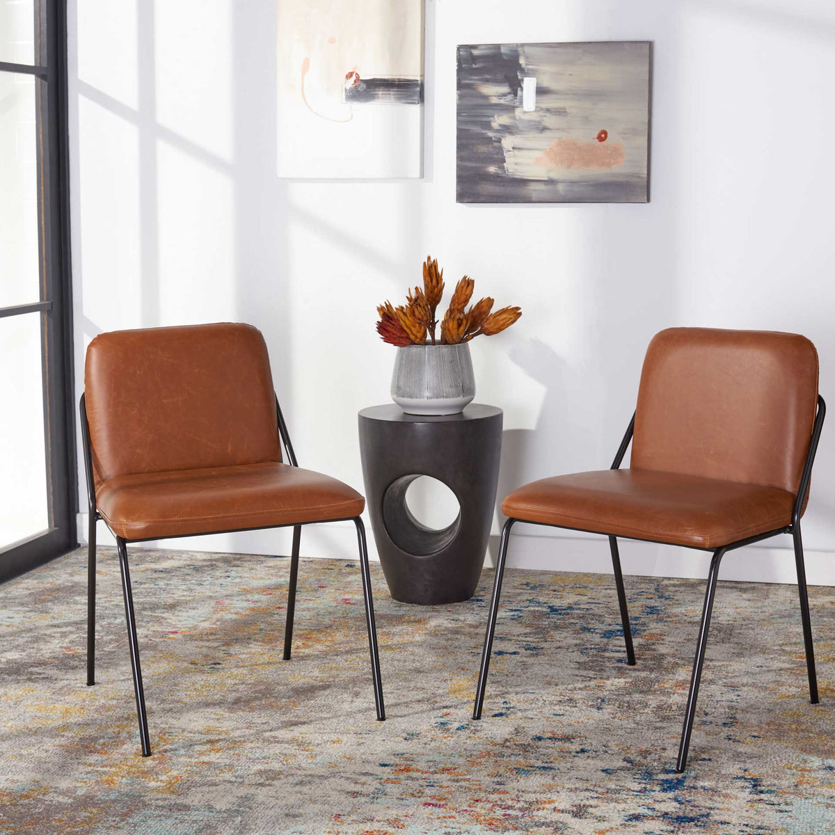 A matching pair of brown cushioned chairs adds warmth and easygoing style to a bright living space