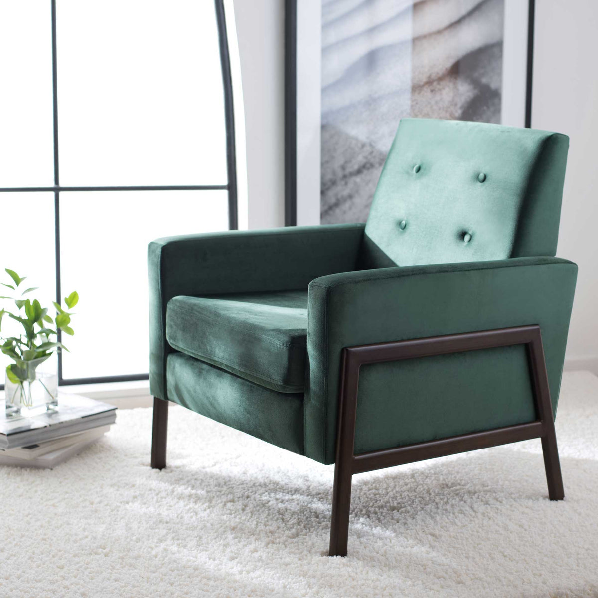 Malachite green velvet and wood-look metal framing add warmth beside a bright window