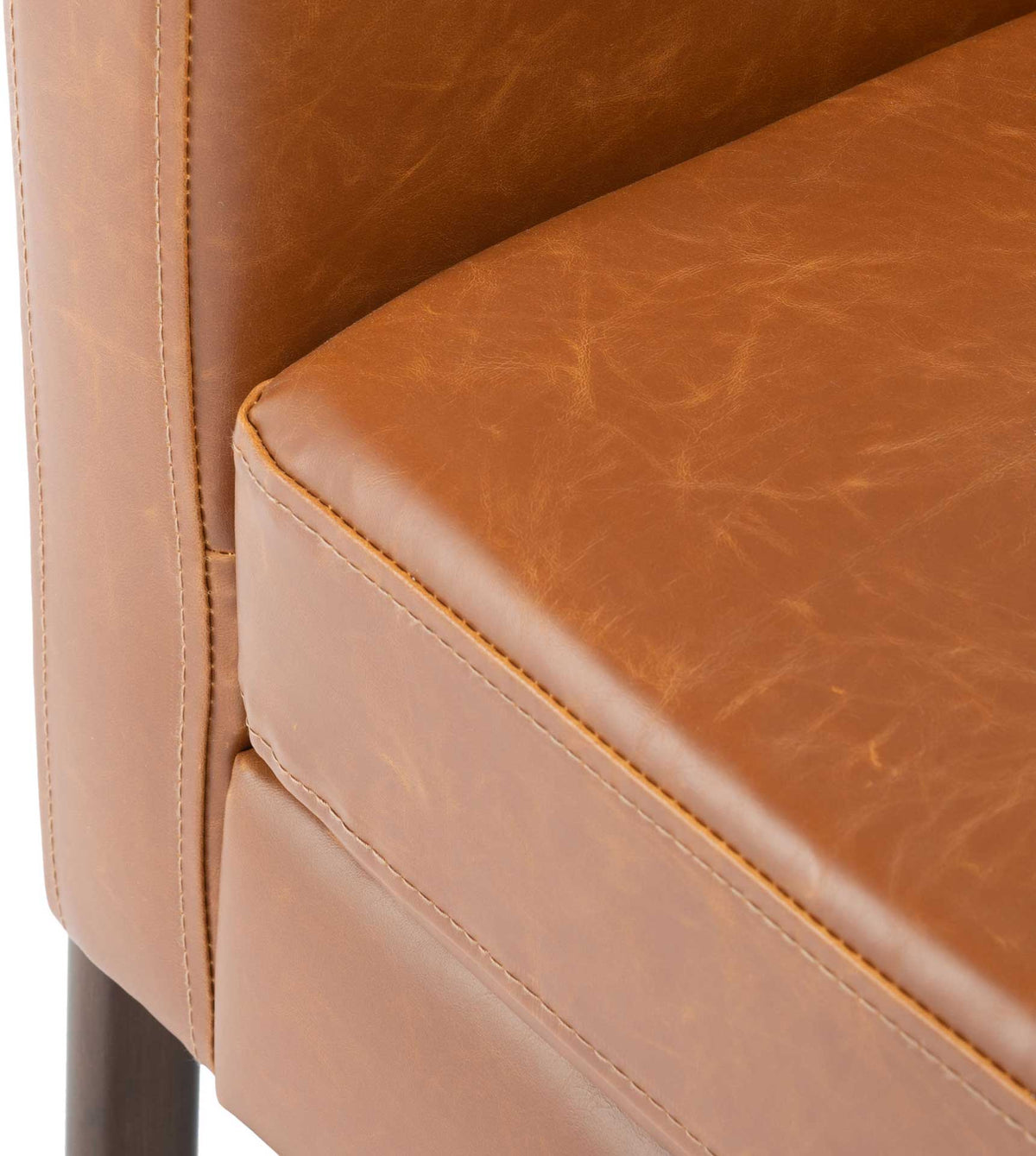 Light brown vegan leather upholstery shows fine topstitching along the thick seat cushion