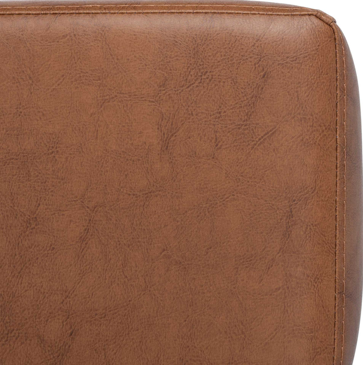 Subtle tonal variation and neat edge stitching enrich the cognac vegan leather upholstery.